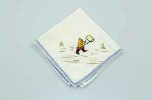 Image of Embroidered napkin with Inuit woman netting